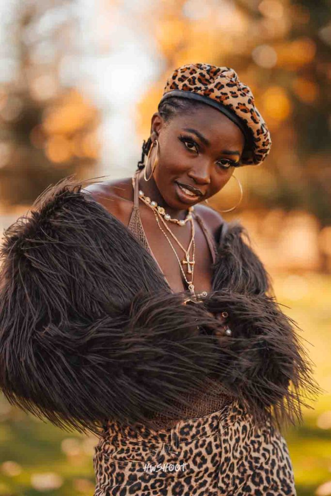 Close portrait of a woman wearing a leopard print beret during a fall photoshoot at Spruce Meadows