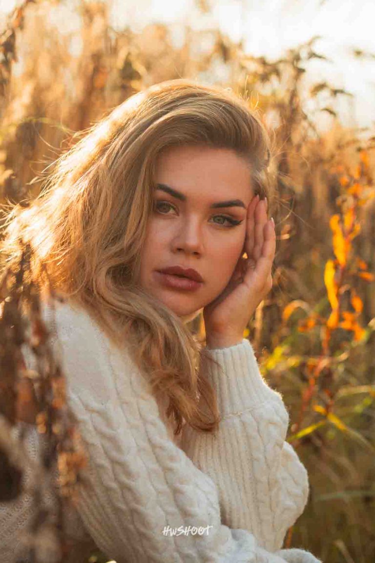 Adele posing outdoors in warm autumn sunlight