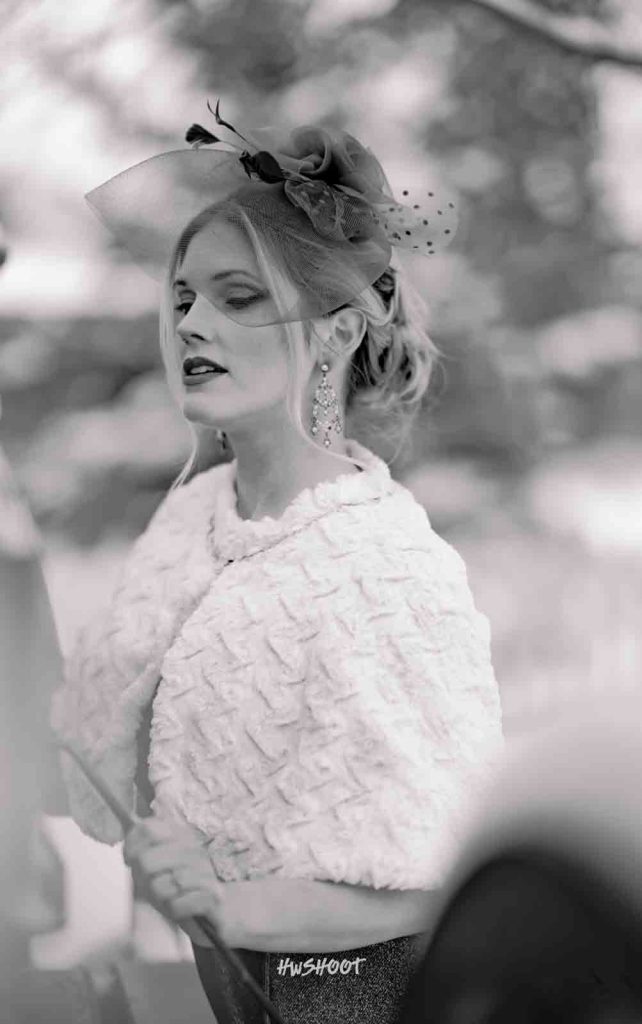 Vintage bride posing beside a carriage during a winter wedding photoshoot in Calgary